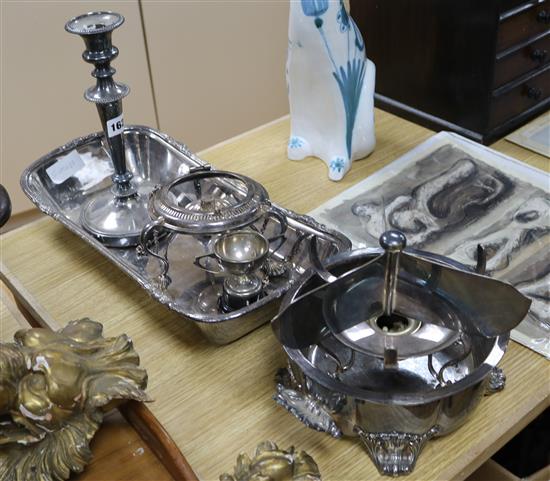 A large rectangular plated bread dish, a single plated Victorian candlestick and two plated spirit stands,